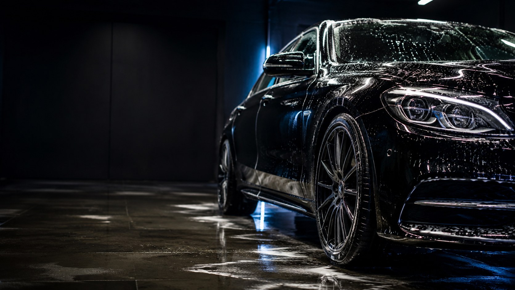 Glossy black car after a Prime Auto Detailing wash